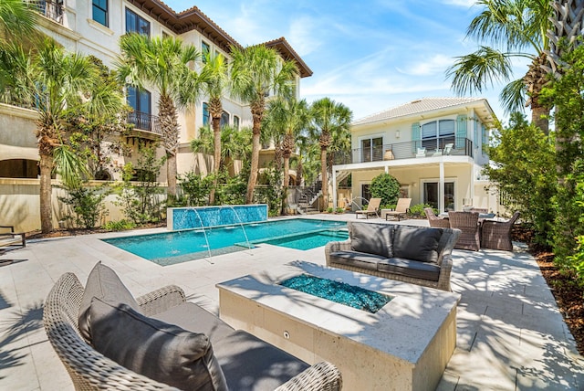 view of pool featuring a patio area, a fenced in pool, an outdoor living space with a fire pit, and fence