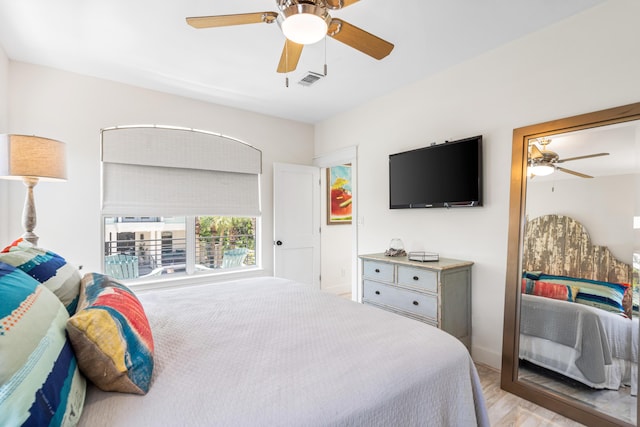 bedroom with light wood-type flooring, visible vents, and a ceiling fan