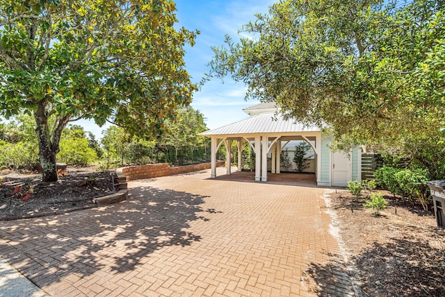 surrounding community featuring a gazebo and decorative driveway