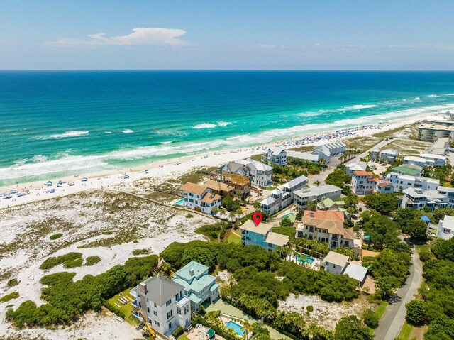 drone / aerial view featuring a water view and a view of the beach