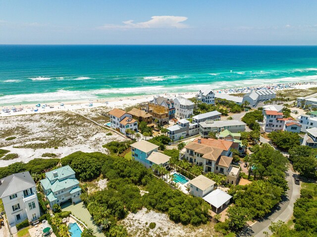 bird's eye view featuring a view of the beach and a water view