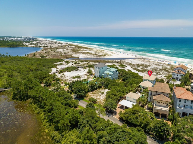 drone / aerial view featuring a beach view and a water view