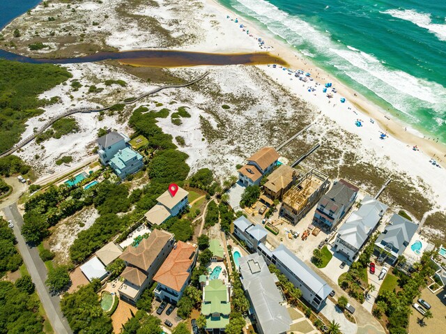 drone / aerial view with a water view and a beach view