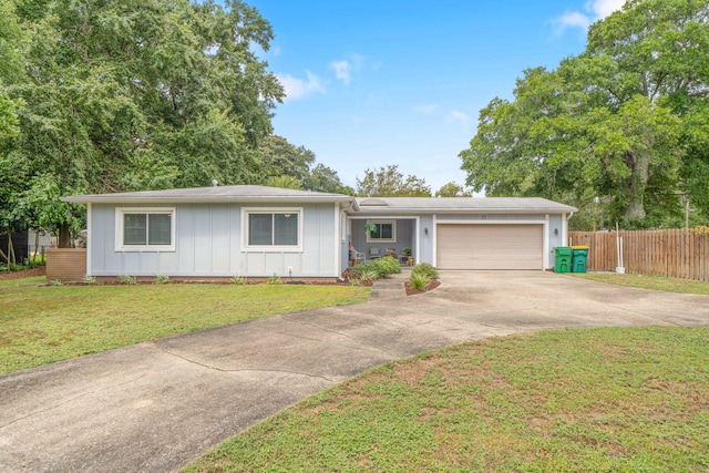 ranch-style home with a garage and a front lawn