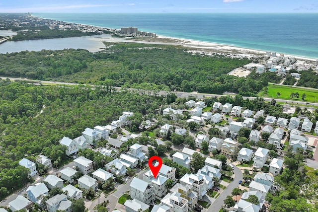 birds eye view of property with a beach view and a water view