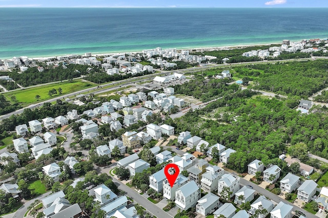 birds eye view of property featuring a view of the beach and a water view