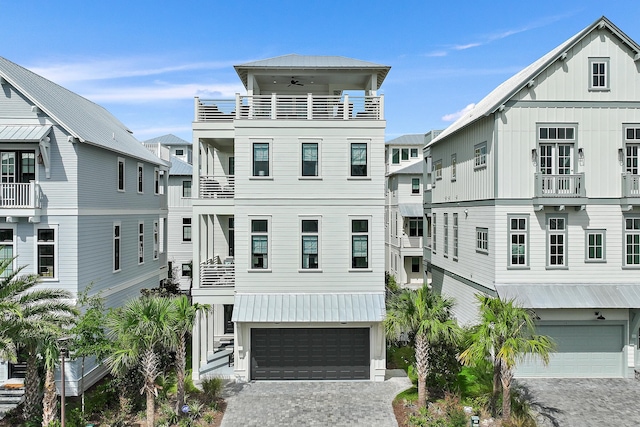 view of front facade with a garage and a balcony