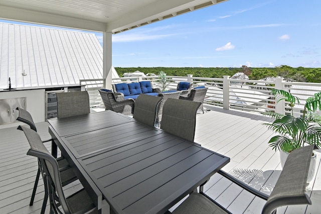 wooden terrace with an outdoor hangout area