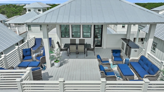 exterior space featuring a balcony, outdoor lounge area, and sink