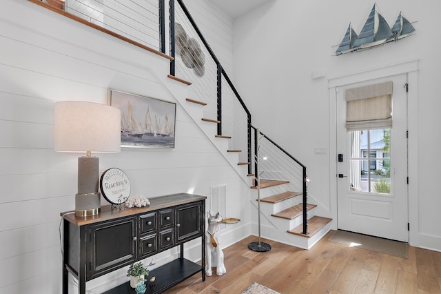 entrance foyer with a high ceiling and wood-type flooring