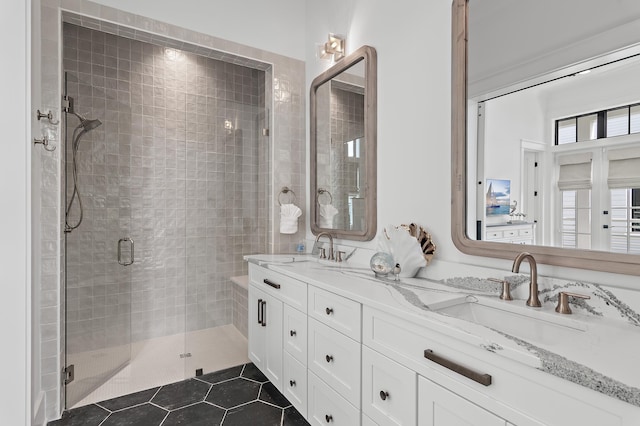 bathroom with vanity, a shower with shower door, and tile patterned floors