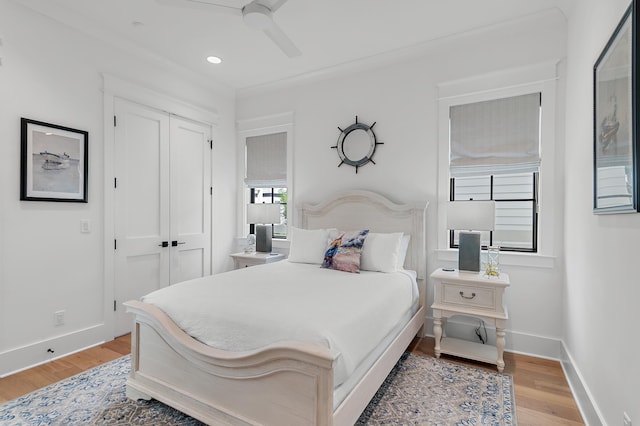 bedroom featuring hardwood / wood-style floors, ceiling fan, and a closet