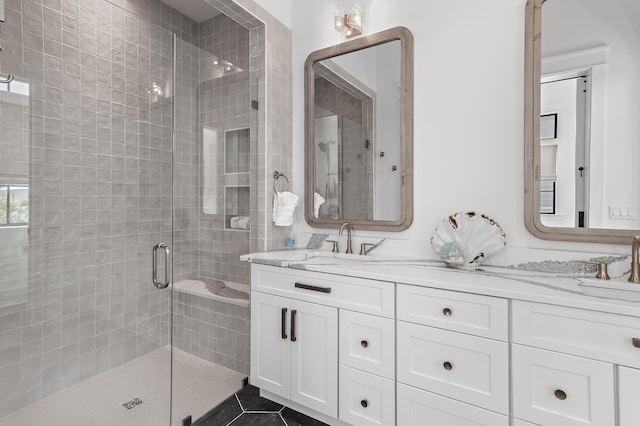 bathroom featuring a shower with shower door, tile patterned flooring, and vanity