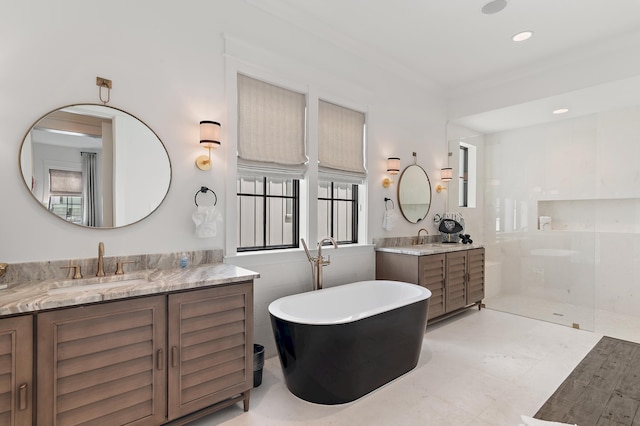 bathroom with crown molding, vanity, plenty of natural light, and shower with separate bathtub