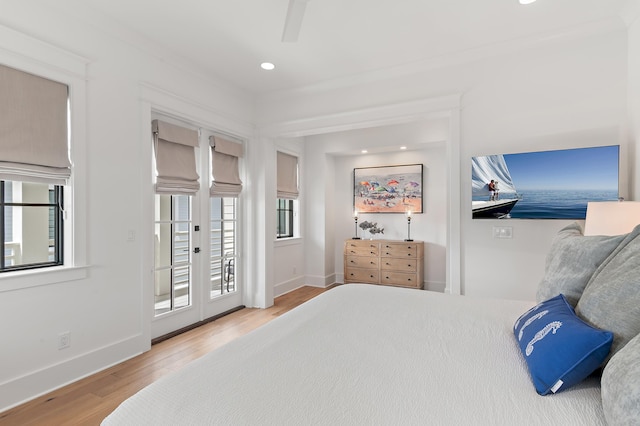 bedroom featuring french doors, access to exterior, ceiling fan, and light hardwood / wood-style floors