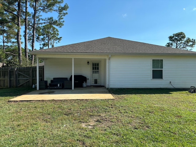 rear view of property with a patio, an outdoor living space, and a yard