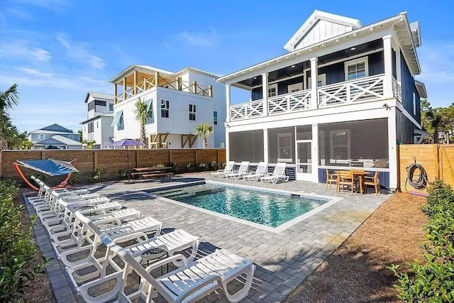 back of property with a balcony and a patio area