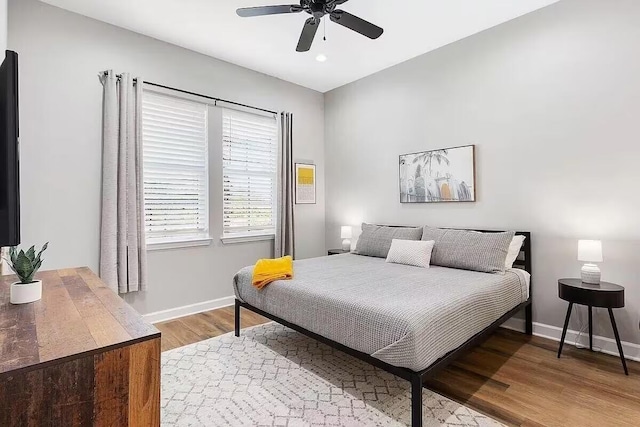 bedroom with hardwood / wood-style floors and ceiling fan