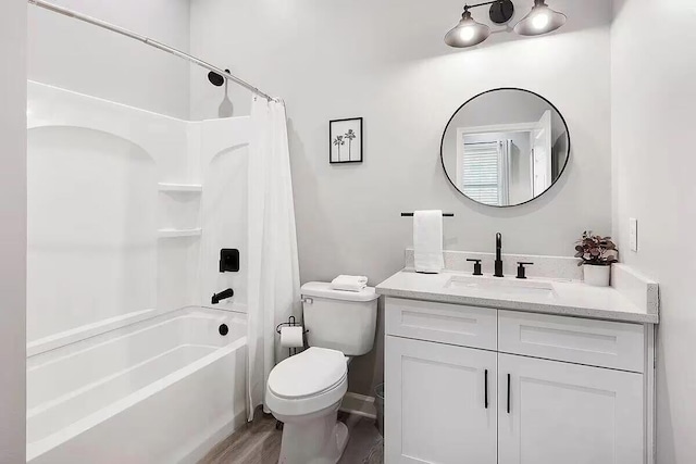 full bathroom featuring toilet, hardwood / wood-style flooring, shower / tub combo with curtain, and vanity