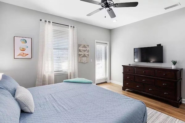 bedroom with light hardwood / wood-style flooring and ceiling fan