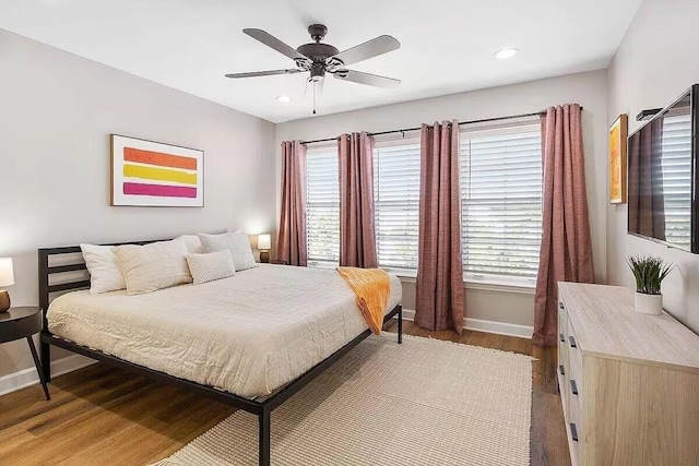 bedroom with ceiling fan and wood-type flooring