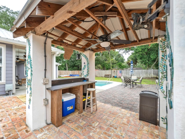 view of patio with exterior bar, ceiling fan, and a gazebo