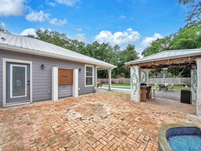 view of patio featuring a fenced in pool and a gazebo