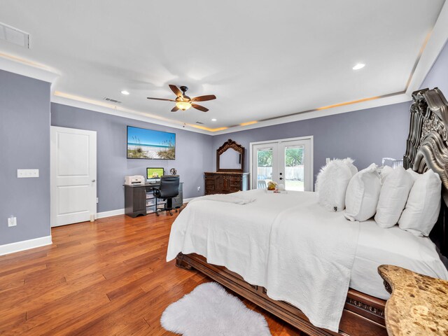 bedroom with wood finished floors, french doors, visible vents, and baseboards