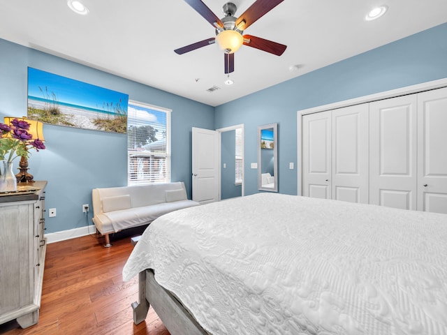 bedroom with baseboards, recessed lighting, wood finished floors, a closet, and a ceiling fan