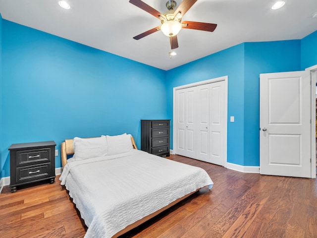 bedroom featuring a closet, ceiling fan, and dark hardwood / wood-style floors