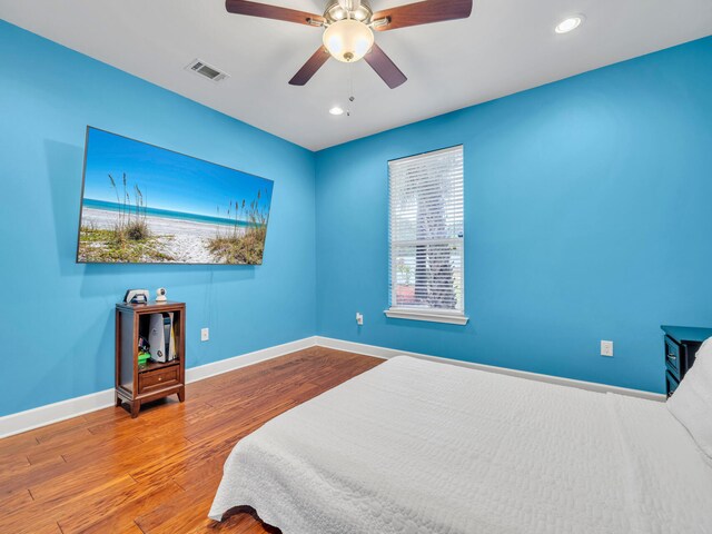 bedroom with wood-type flooring and ceiling fan