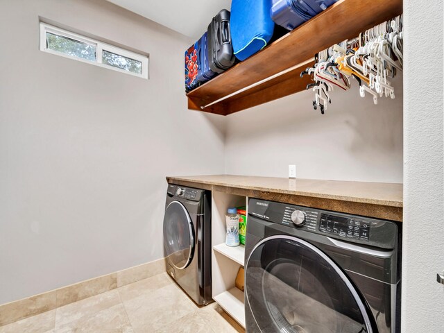 laundry room with light tile patterned floors and independent washer and dryer