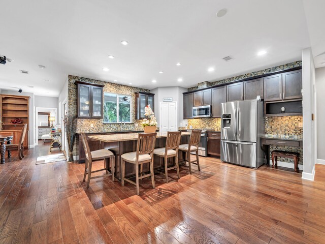 dining area with wood-type flooring and sink