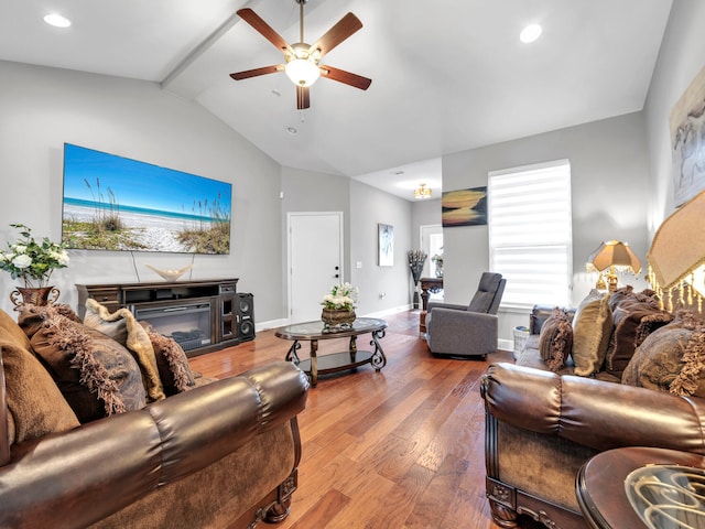 living room featuring lofted ceiling, ceiling fan, hardwood / wood-style flooring, and a fireplace