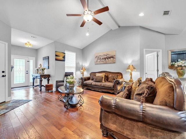 living room featuring ceiling fan, hardwood / wood-style flooring, and lofted ceiling with beams