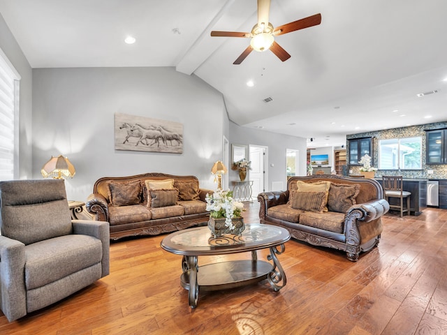 living room with visible vents, recessed lighting, lofted ceiling with beams, and hardwood / wood-style floors