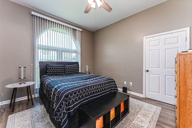 bedroom with ceiling fan and hardwood / wood-style floors