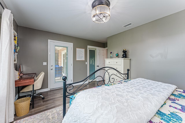 bedroom featuring access to outside and dark wood-type flooring