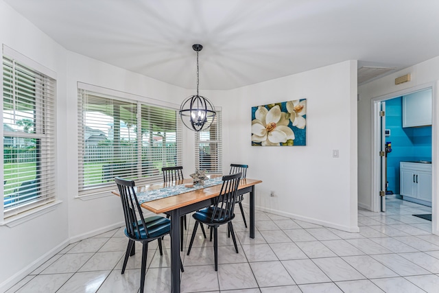 dining area featuring an inviting chandelier and light tile patterned floors