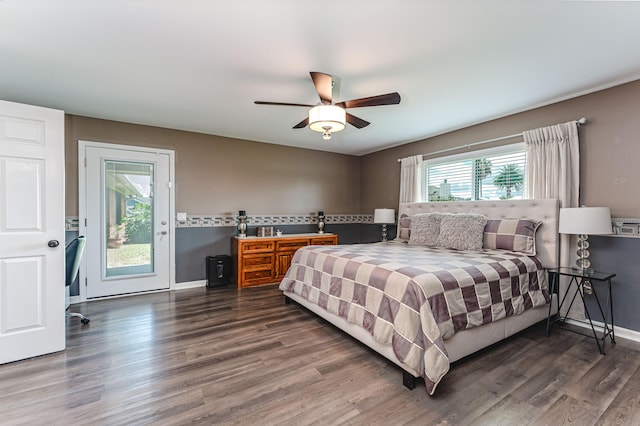 bedroom featuring access to outside, dark hardwood / wood-style flooring, and ceiling fan