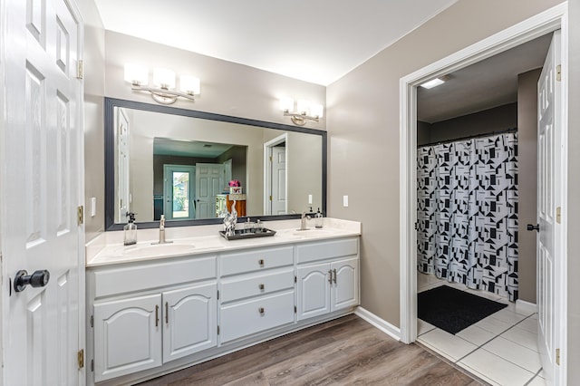 bathroom with vanity, curtained shower, and hardwood / wood-style flooring