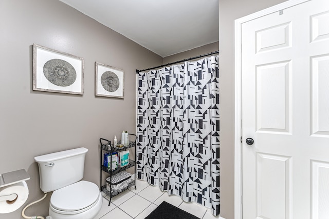 bathroom with tile patterned flooring, a shower with curtain, and toilet