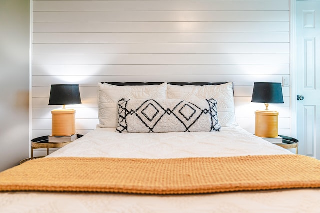 unfurnished bedroom featuring wood walls