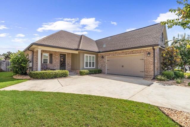 view of front of home with a front yard and a garage