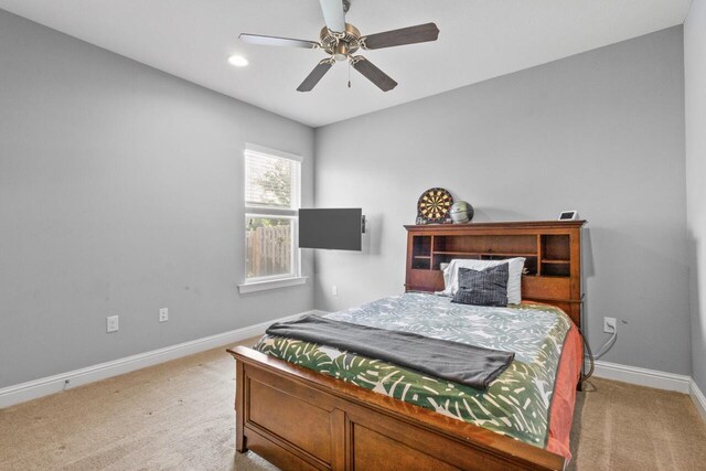 bedroom featuring light carpet and ceiling fan