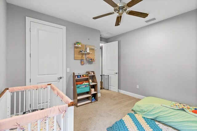 bedroom with light carpet and ceiling fan