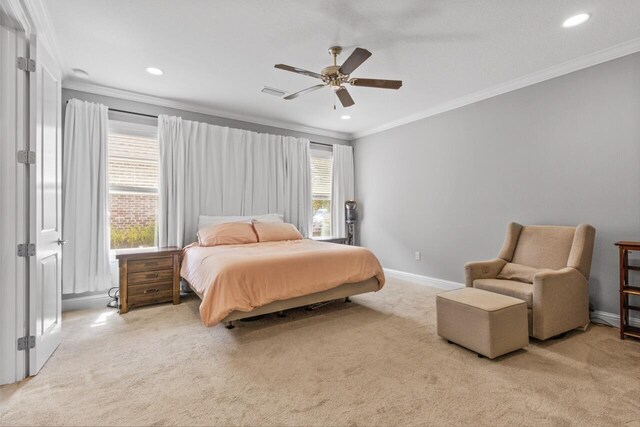 carpeted bedroom with ornamental molding, multiple windows, and ceiling fan