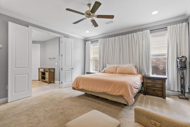 carpeted bedroom featuring ornamental molding and ceiling fan