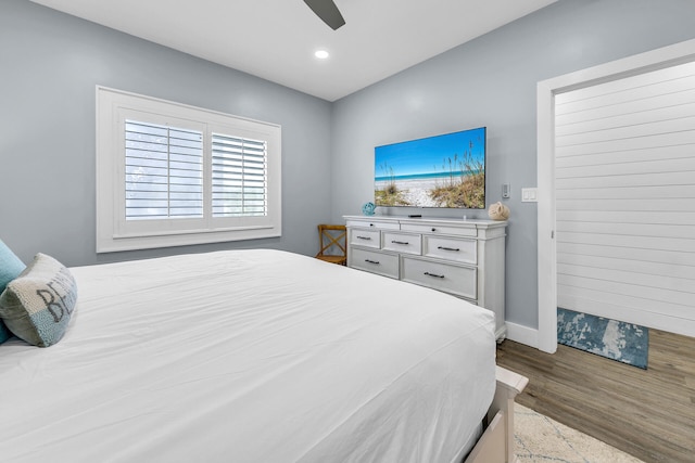 bedroom featuring ceiling fan and dark wood-type flooring