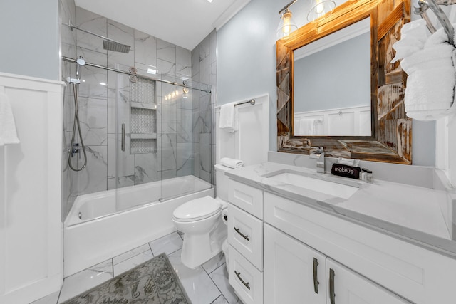 full bathroom featuring bath / shower combo with glass door, vanity, and toilet